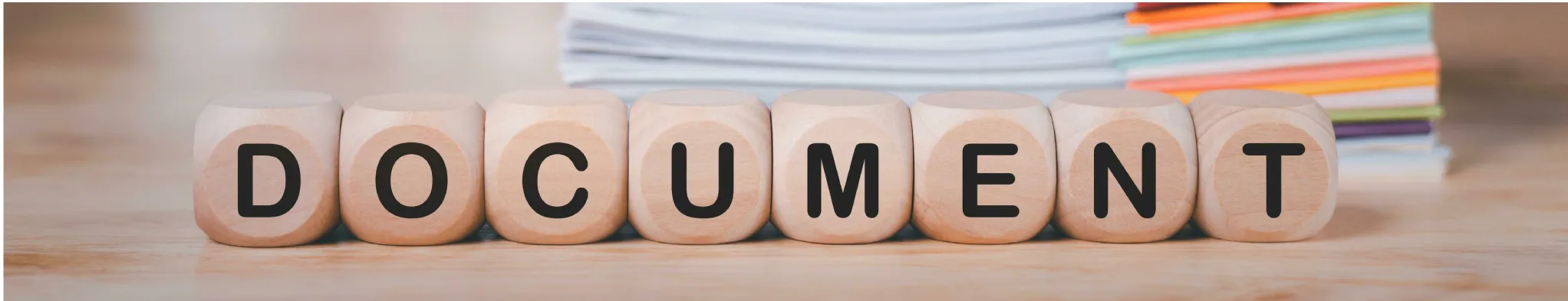 Wooden blocks spelling document on a desk