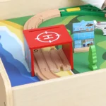 Close-up of the activity table top with wooden train track and bricks