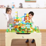 Child playing with building bricks on the kids activity play table