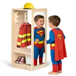 Two boys in superhero costumes using the kids dress up center