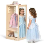 Two girls in princess dresses playing at the dress up center