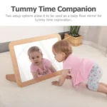 Babies using the mirror flat on the floor for tummy time exploration