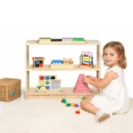 Toddler tidying toys into the two-tier storage cabinet