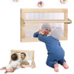 Montessori safety mirror set up on floor stands and on the wall with pull-up bars