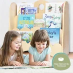 Two girls reading picture books from the low bookshelf