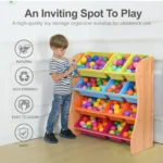 Boy tidying toys into the bins of the tall storage cabinet