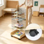 Teacher rolling the full drying rack across the art room