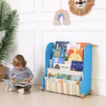 Toddler reading a picture book from the sling book rack at floor level
