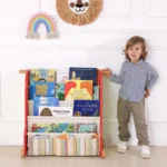 Child standing beside the front-facing book display rack