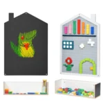 Clear storage box holding building blocks beneath the house shaped wall board