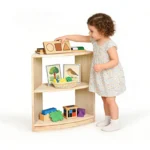 Toddler reaching for toys on the curved modular corner shelf