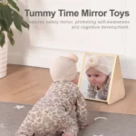 Baby on tummy looking at their reflection in the triangular floor mirror