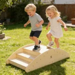 Two children stepping up the textured climbing bridge in a garden