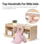 Toddler pulling up on the top handrails of the storage cubby
