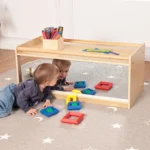 Children playing with blocks in front of the mirrored storage cubby