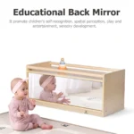 Baby using the shatterproof back mirror for tummy time play