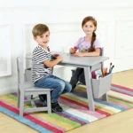 A boy and a girl doing crafts at the grey kids table set