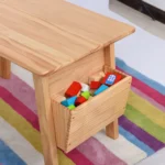 Close-up of the built-in side storage cubby filled with toys