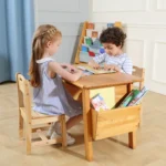 Two girls drawing together at the natural wood kids table