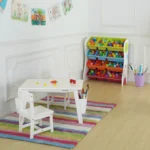 White kids table and chair set in a playroom with a colourful rug