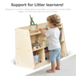 Child pulling up on the top handrail to reach books on the shelf