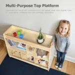 Toddler using the wide flat top of the bookshelf as a play surface