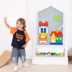 Child building on the house shaped wall panel with a pink storage box below